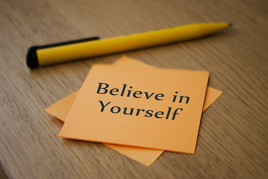Motivational Sticky Note with Believe in Yourself Text and Yellow Pen on Wooden Desk HD wallpaper
