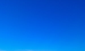 Vibrant Blue Sky Gradient with Soft Horizon Glow and Minimalist Clouds HD wallpaper