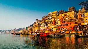 Varanasi Ghats Along the Ganges River with Boats and Historic Architecture HD wallpaper