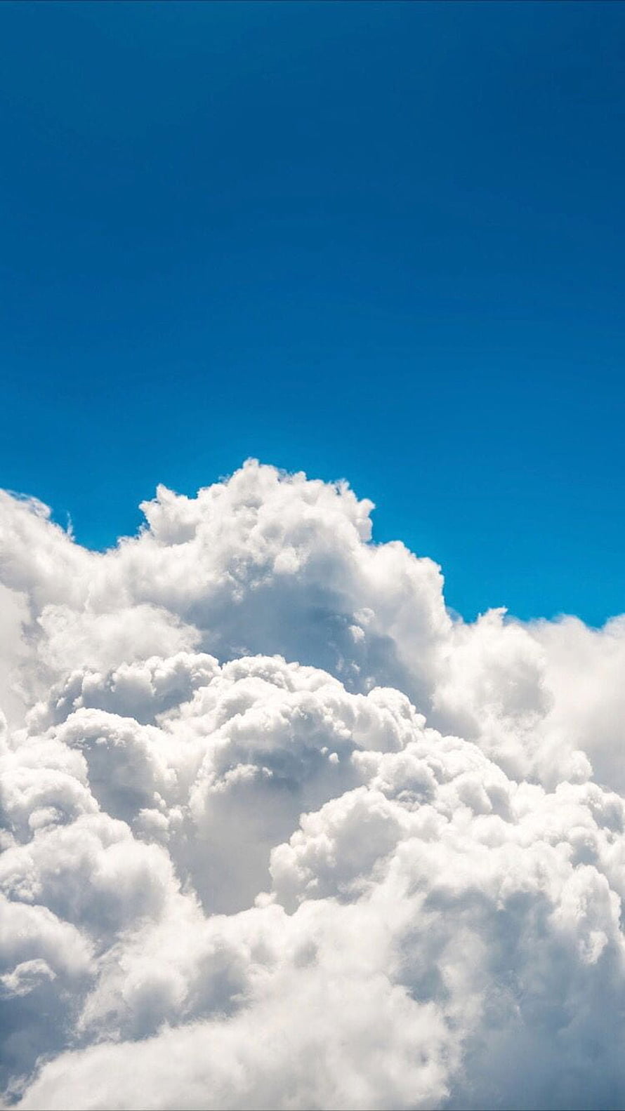 Majestic Fluffy White Cumulus Clouds Against a Deep Blue Sky HD phone wallpaper
