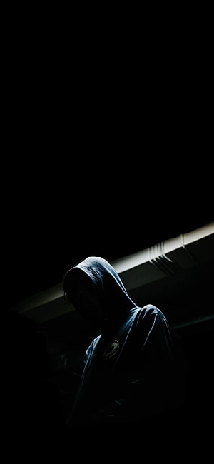 Mysterious Hooded Figure in Dramatic Low-Key Lighting HD phone wallpaper