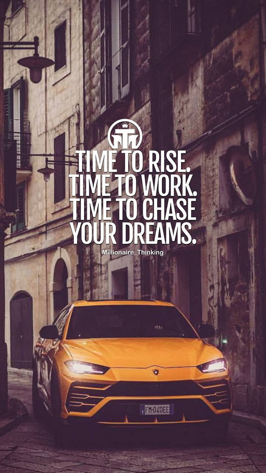 Orange Lamborghini Urus Parked on a Historic European Street with Motivational Quote Overlay HD phone wallpaper
