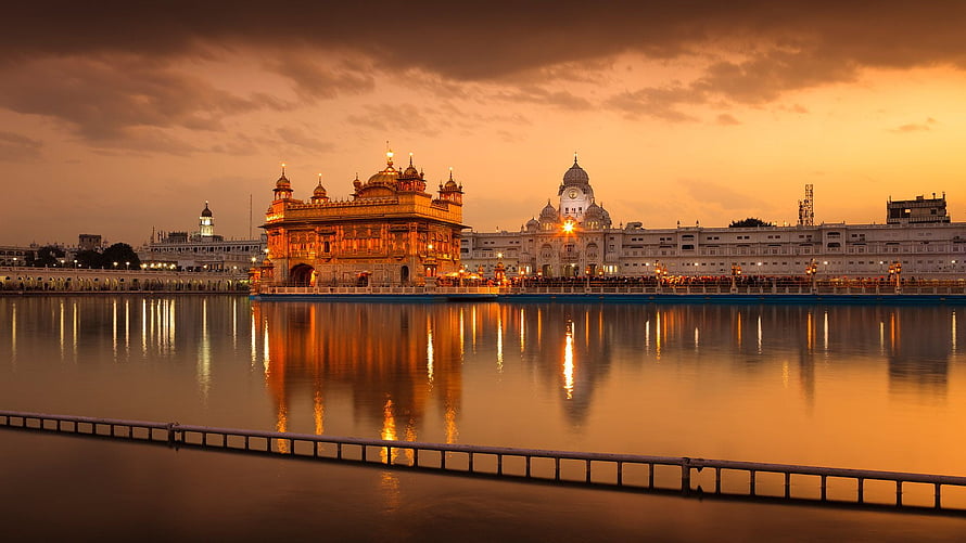 Golden Temple at Sunset with Reflections in the Sacred Pool HD wallpaper