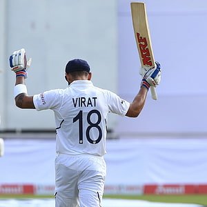 Virat Kohli Celebrating a Milestone with Bat Raised in White Test Kit HD phone wallpaper