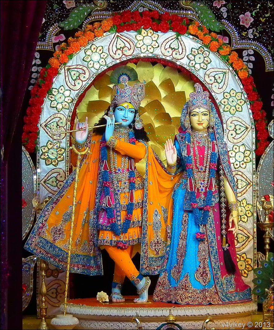 Vibrant Radha Krishna Deities in Ornate Temple Altar with Floral Garlands HD phone wallpaper