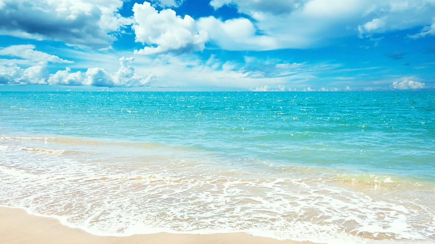 Tropical Beach Landscape With Turquoise Ocean Water And Fluffy White Clouds Under A Bright Blue Sky HD wallpaper
