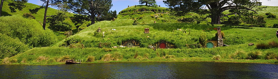 The Shire Hobbiton Movie Set Panorama with Green Hills and Round Doors HD wallpaper