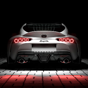 Rear View of Silver Toyota Supra with Glowing Red Tail Lights on Dark Background HD phone wallpaper