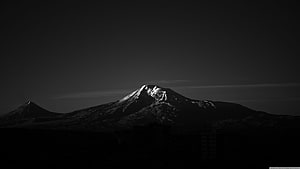 Monochrome Snow-Capped Mountain Peak Silhouette Against Dark Sky HD wallpaper
