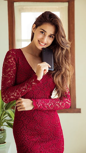 Disha Patani in a Red Lace Dress Holding a Smartphone Indoors HD phone wallpaper