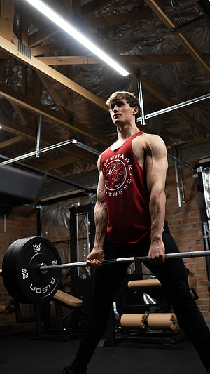 Muscular Athlete Performing Deadlift in Industrial Gym Setting HD phone wallpaper
