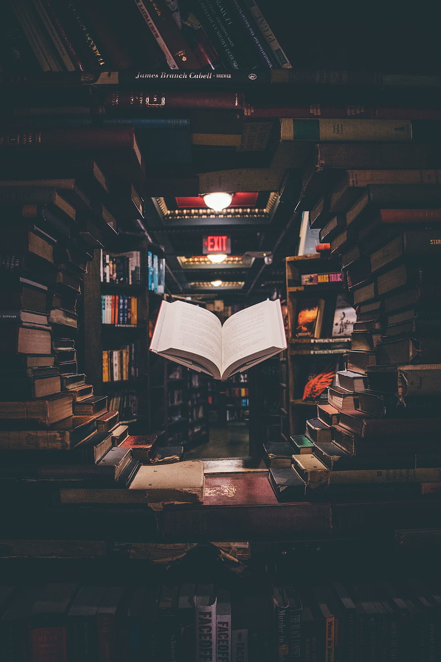 Magical Floating Open Book in a Dark Vintage Library Aisle HD phone wallpaper