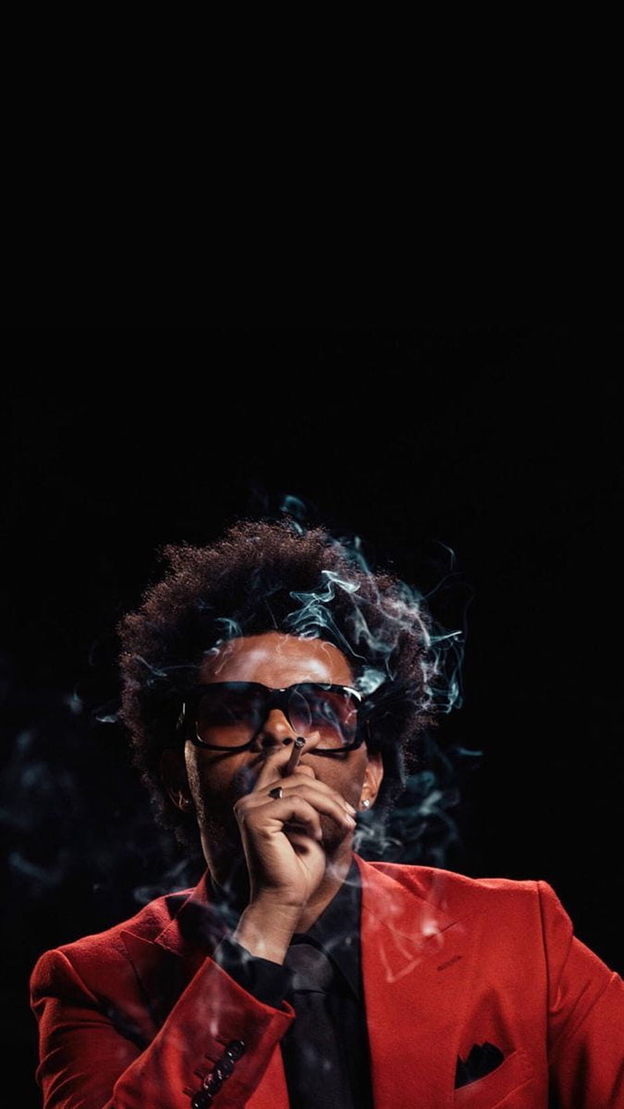 The Weeknd in a red suit smoking a cigarette with dramatic smoke against a black background HD phone wallpaper