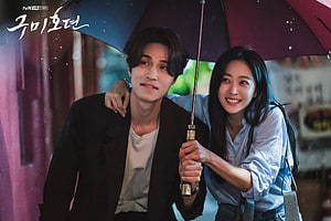 Tale of the Nine Tailed: Romantic Couple Sharing an Umbrella in the Rain HD wallpaper
