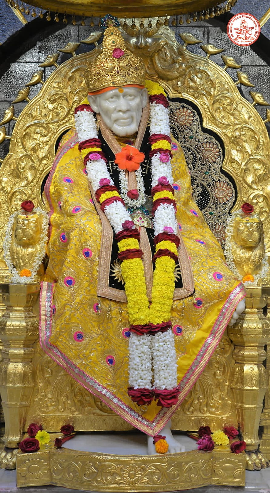 Shirdi Sai Baba Murti Adorned in Golden Garments and Floral Garlands HD phone wallpaper