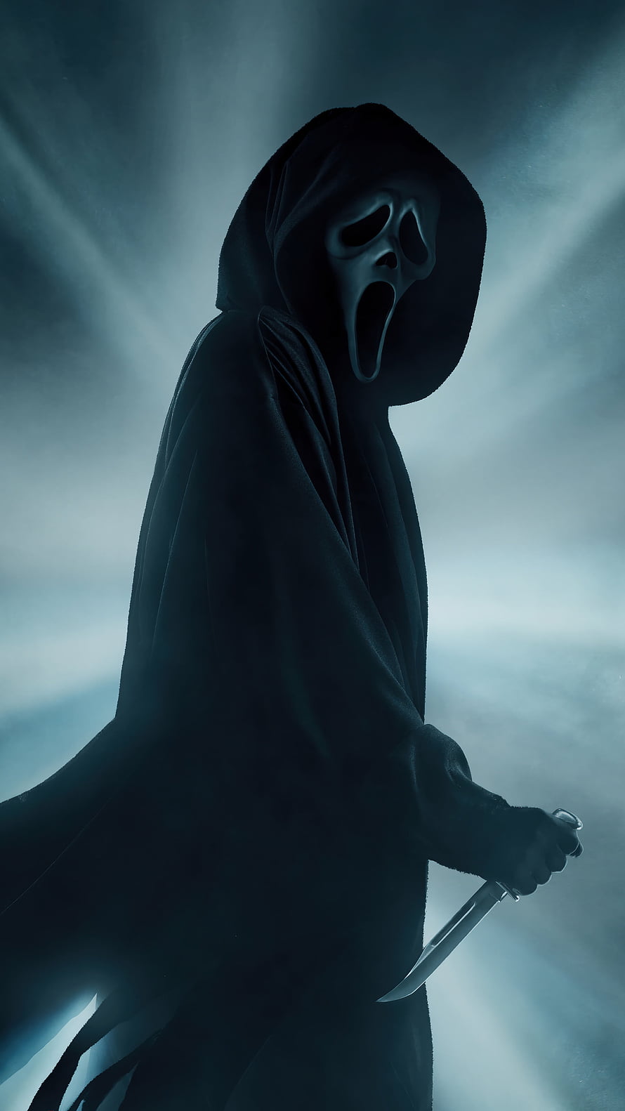 Ghostface from Scream in a dark hooded cloak holding a knife against a misty blue background HD phone wallpaper