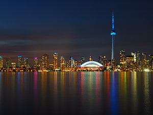 Toronto skyline at night with CN Tower and waterfront reflections on Lake Ontario HD wallpaper