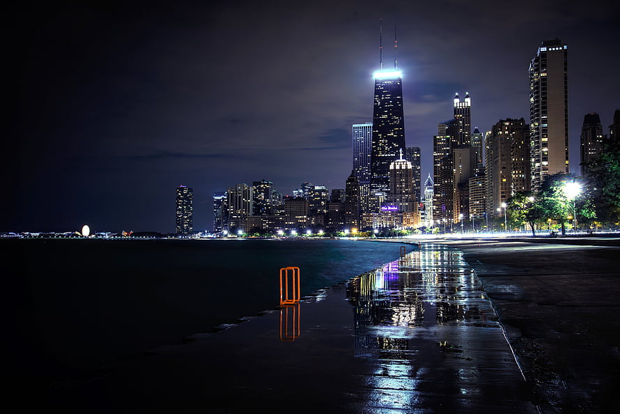 Chicago Skyline at Night with Rainy Lakefront Reflections and Illuminated Skyscrapers HD wallpaper