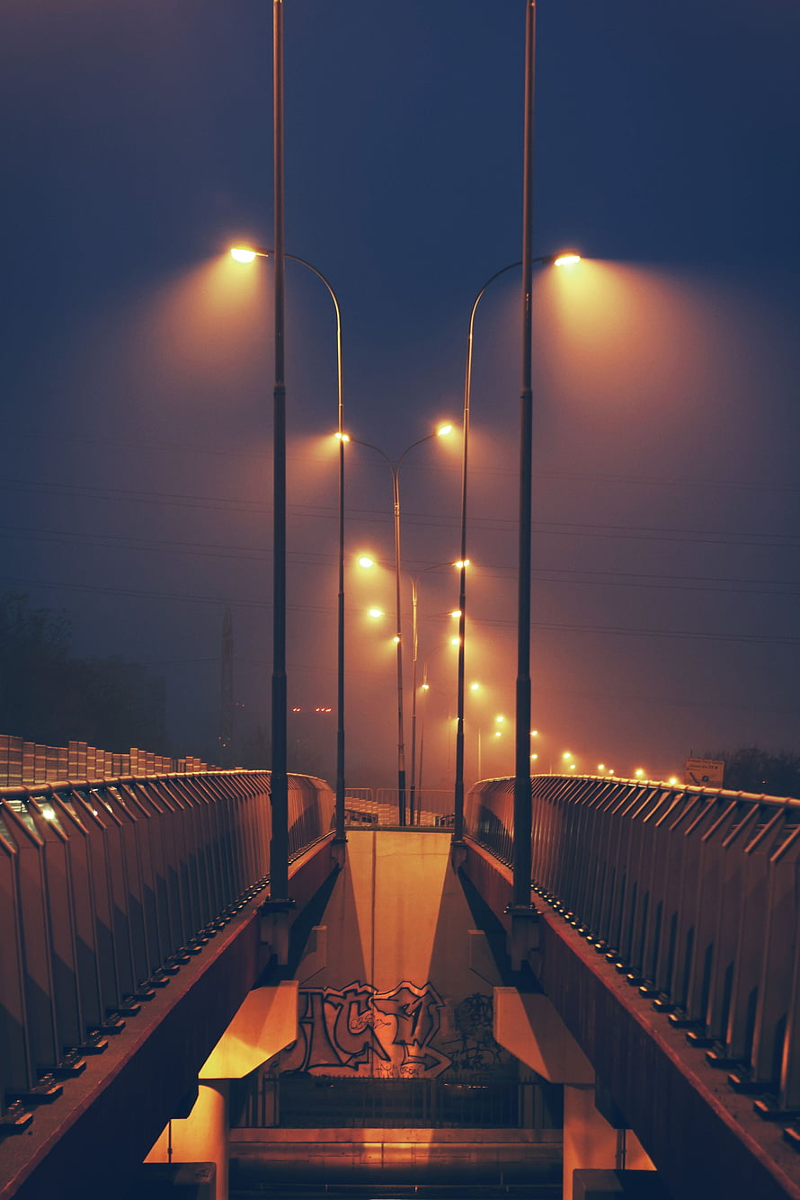 Foggy Urban Pedestrian Bridge at Night with Glowing Streetlights HD phone wallpaper