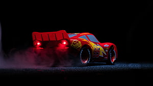 Lightning McQueen 95 Racing Car with Smoke and Red Taillights on Dark Track HD wallpaper