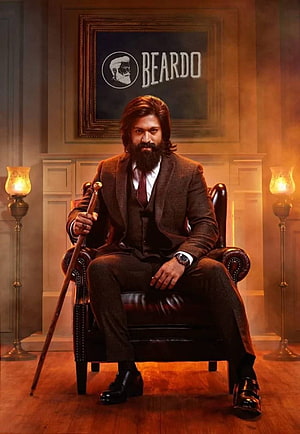 Allu Arjun as Beardo in a brown suit holding a cane, sitting in a leather chair with vintage lamps and a framed logo in the background HD phone wallpaper