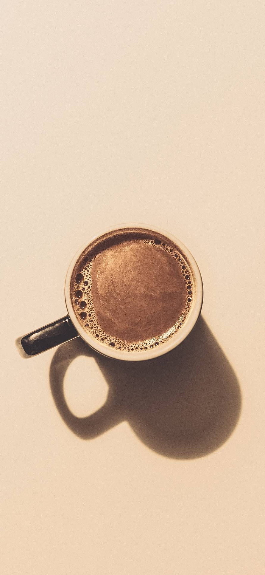 Top View of Frothy Coffee in a White Mug with Strong Shadow on Beige Background HD phone wallpaper