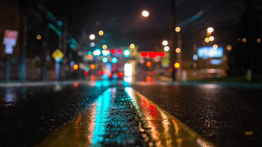Rainy City Street at Night with Blurred Bokeh Lights and Wet Asphalt Reflections HD wallpaper