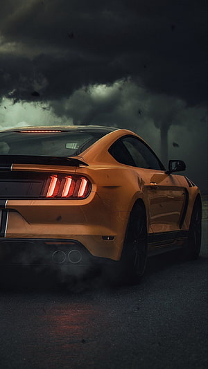 Orange Ford Mustang GT Rear View in Stormy Weather with Smoke and Dark Clouds HD phone wallpaper