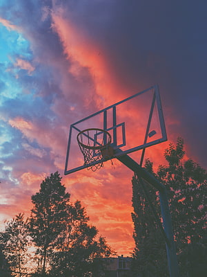 Basketball Hoop Silhouette Against Vibrant Sunset Sky With Dramatic Clouds HD phone wallpaper