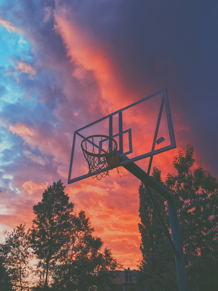 Basketball Hoop Silhouette Against Vibrant Sunset Sky With Dramatic Clouds HD phone wallpaper