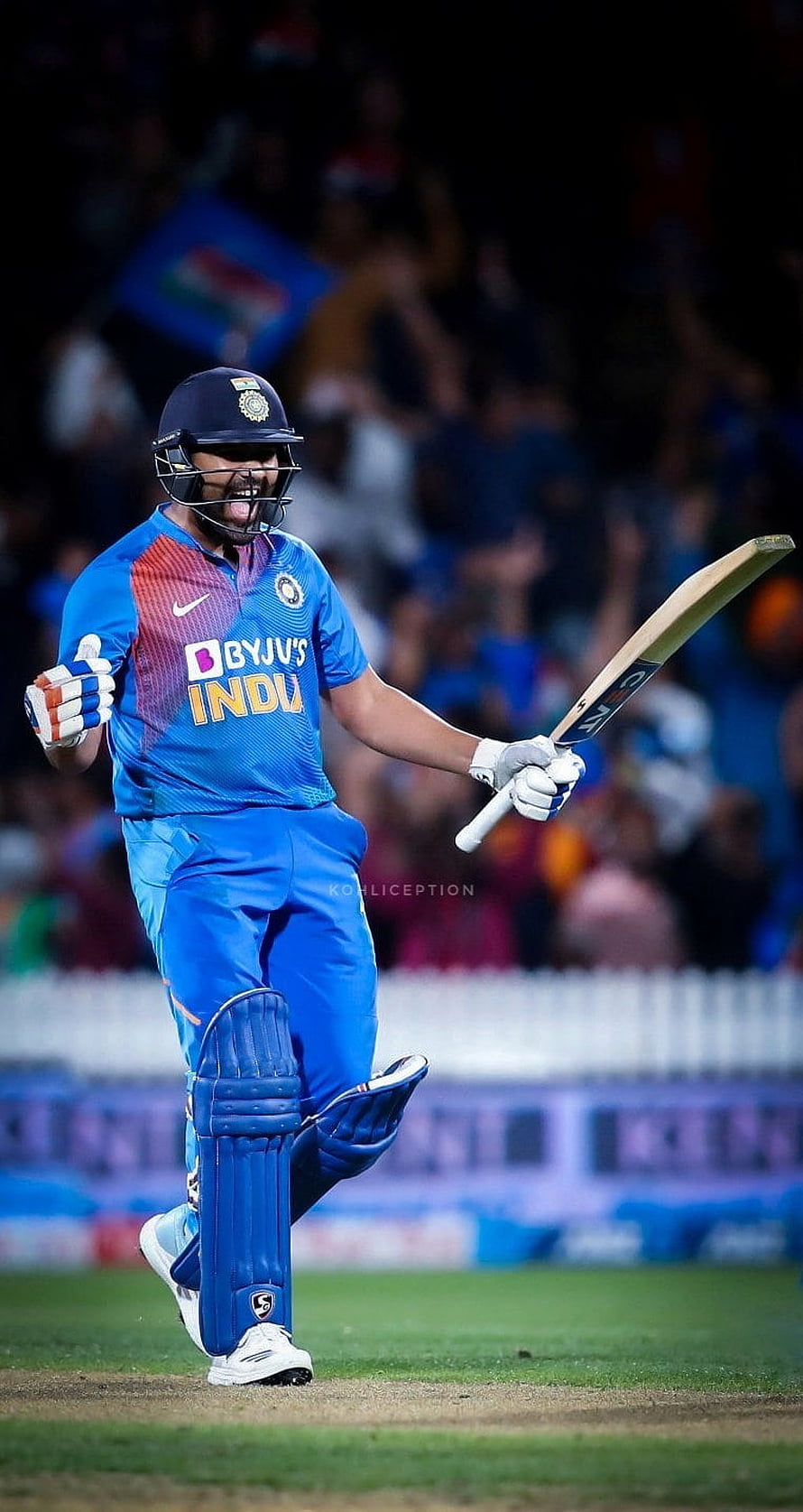 Rohit Sharma celebrating a cricket milestone in the Indian national team blue jersey HD phone wallpaper