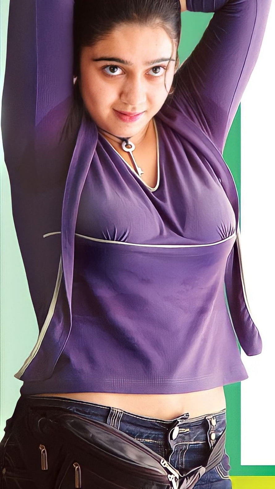 Charmi Kaur in a purple top with arms raised against a green and white background HD phone wallpaper