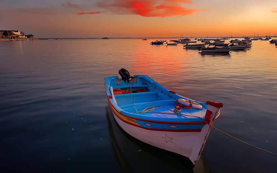 Colorful Fishing Boat Anchored in Calm Harbor During Golden Sunset HD wallpaper