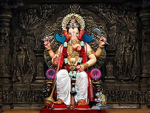 Lord Ganesha Sitting Statue With Axe And Lotus In Ornate Temple Setting HD wallpaper