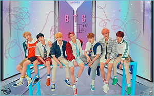 BTS Idol Group Photo Sitting on Blue Bench with Colorful Background HD wallpaper