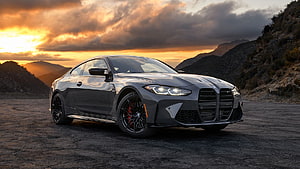 BMW M4 Competition Coupe in Dark Grey Parked on Mountain Road at Sunset HD wallpaper