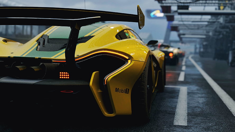 Yellow McLaren Senna GTR Racing Car on Wet Track with Mobil 1 Decal HD wallpaper