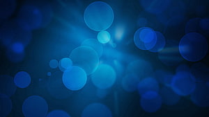 Abstract Blue Bokeh Background With Soft Glowing Circles And Light Flares HD wallpaper