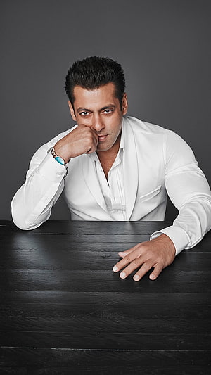 Salman Khan in White Shirt Leaning on Dark Table with Intense Gaze, Salman Khan, Bollywood Actor HD phone wallpaper