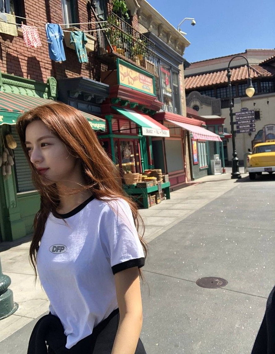 Go Yoon Jung in White T-Shirt on a Sunny Street with Vintage Shops and a Yellow Taxi HD phone wallpaper