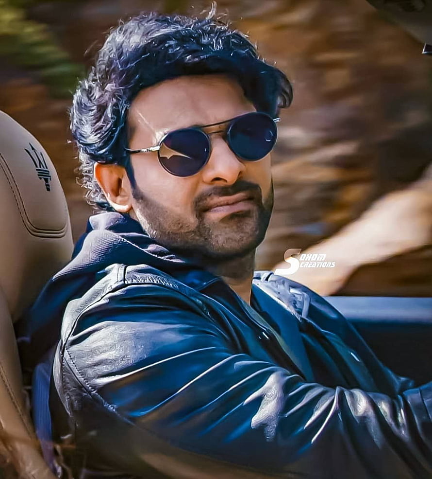 Prabhas in a black leather jacket and round sunglasses sitting in a car HD phone wallpaper