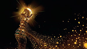 FIFA World Cup Trophy Glowing with Golden Particles on Black Background HD wallpaper
