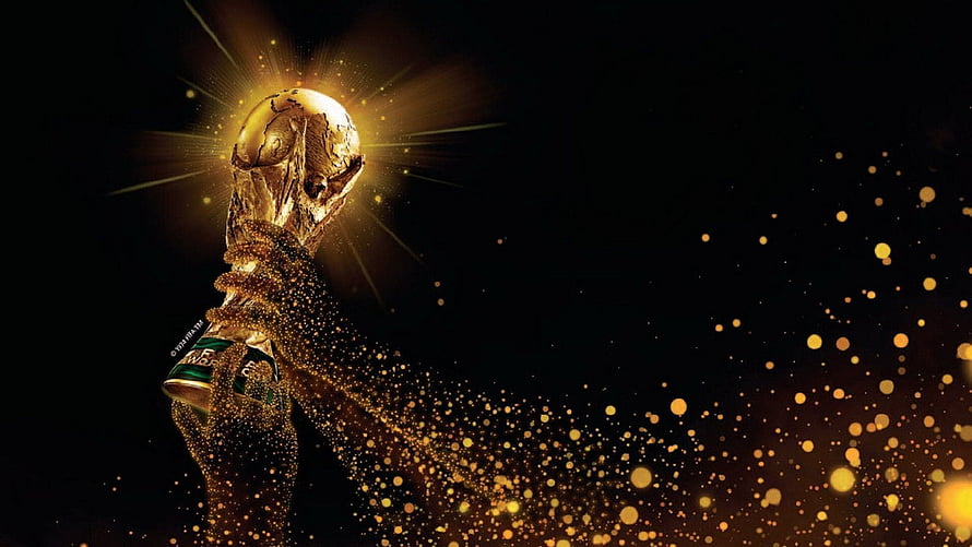 FIFA World Cup Trophy Glowing with Golden Particles on Black Background HD wallpaper
