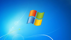 Windows 7 Default Desktop Wallpaper with Blue Background and Waving Flag Logo HD wallpaper