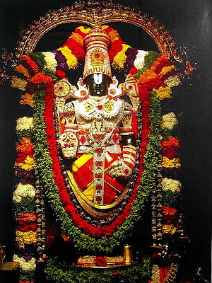 Lord Ayyappa Murali Dharan adorned with vibrant flower garlands and golden ornaments in a temple setting HD phone wallpaper