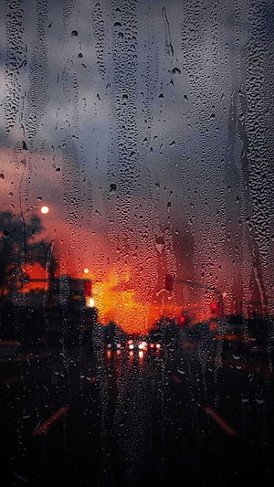 Moody Rainy Cityscape at Dusk Viewed Through a Wet Windshield HD phone wallpaper
