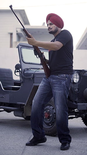 Man in Red Turban Holding Rifle Standing in Front of Vintage Military Jeep, Sidhu Moose Wala Black, Jeep, Gun Background, gun, background HD phone wallpaper