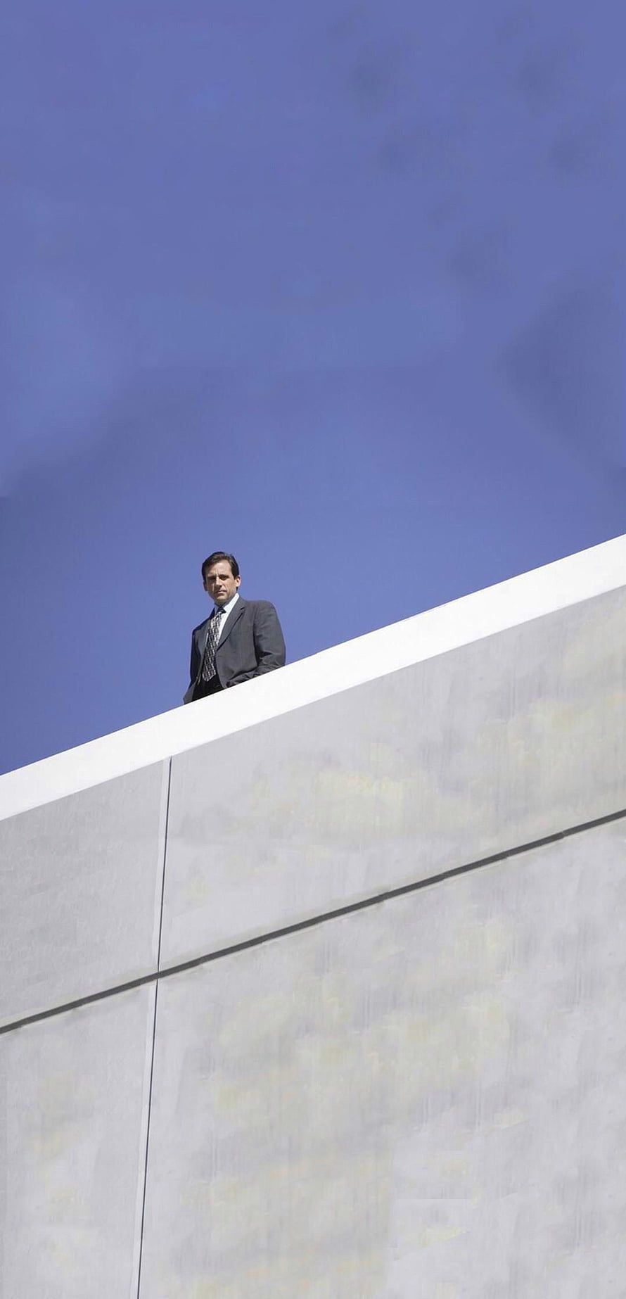 Michael Scott from The Office Standing on a Concrete Wall Under a Clear Blue Sky HD phone wallpaper