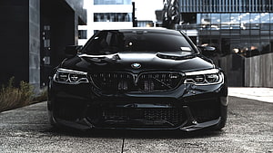 Black BMW M5 F90 Front View in Urban Setting HD wallpaper