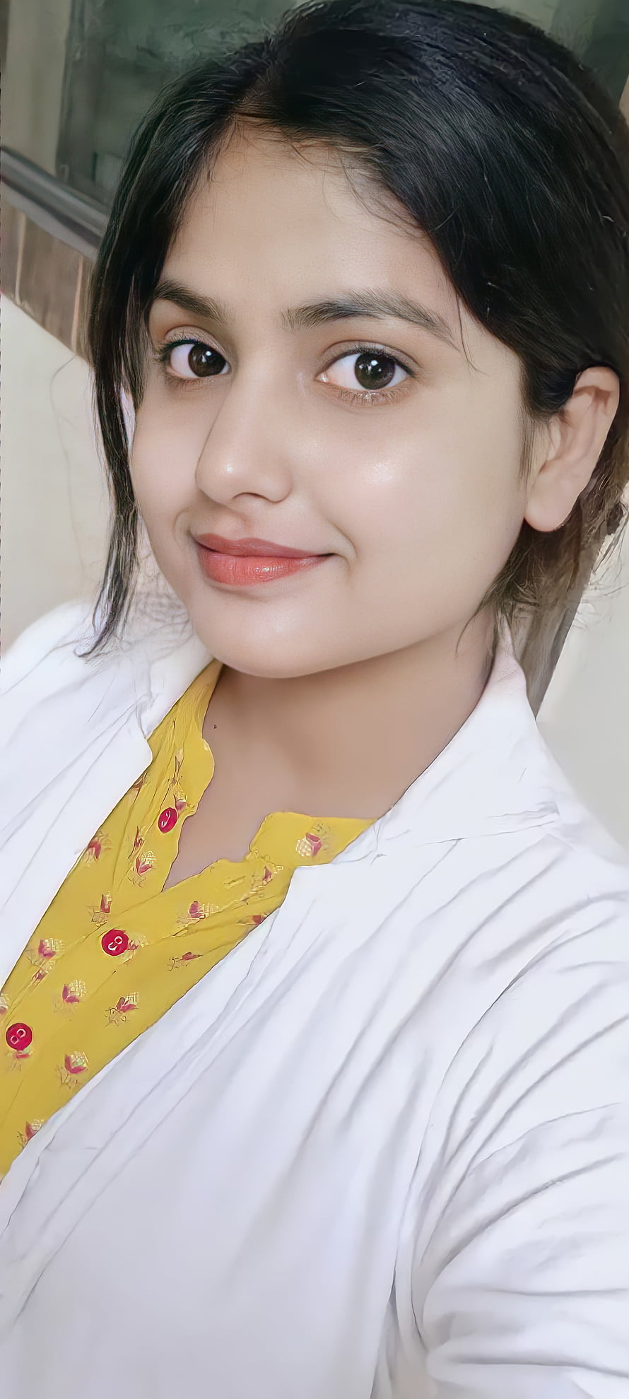 Portrait of a woman with dark hair smiling softly, wearing a white shirt over a yellow patterned top, Beautiful girl, doctor, indian HD phone wallpaper